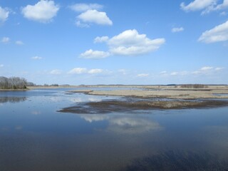 The beautiful scenery of the wetland landscape, with natural reflections of clouds upon the still water. Bombay Hook National Wildlife Refuge, Kent County, Delaware.  