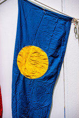 Wrinkeled Palau flag on a wall.