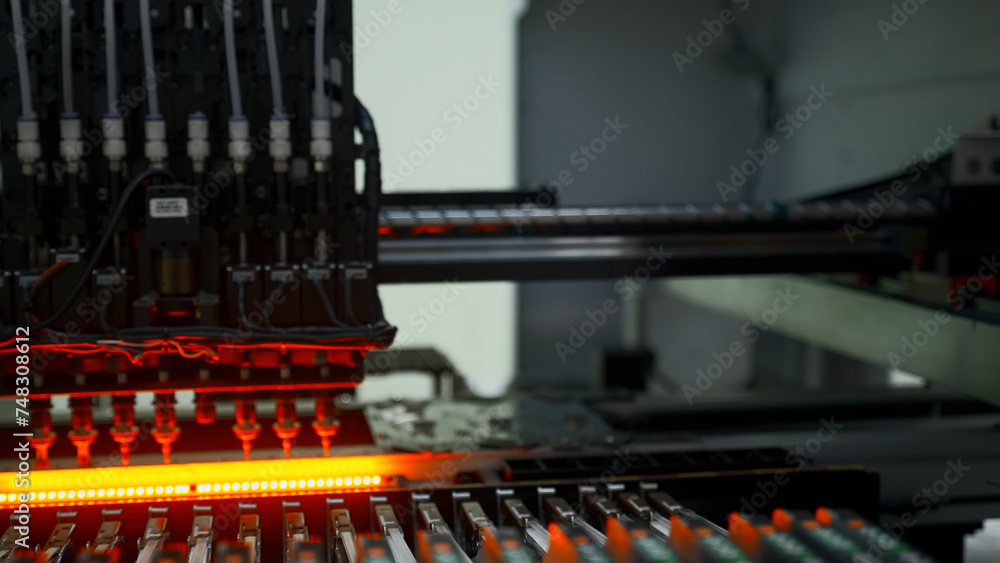 Poster factory machine at work: printed circuit board being assembled with automated mechanism. creative. t