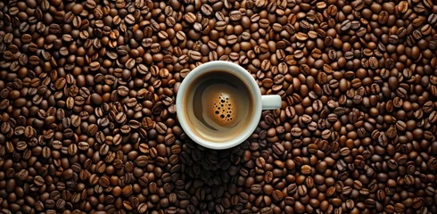 Tuinposter coffee beans with cup in the middle of them © olegganko