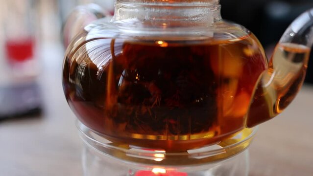 The video features tea leaves gracefully swirling in a teapot, creating a soothing and mesmerizing dance. The gentle infusion captures the essence of tea-making.