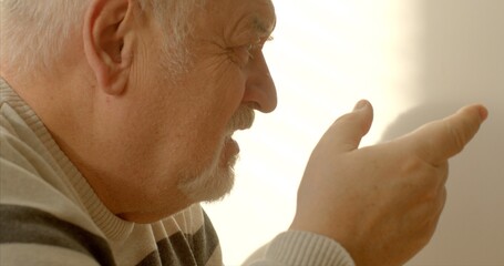 Face close-up. An elderly man engages in effective communication through nonviolent communication,...