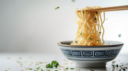 noodles with steam and smoke in bowl  picked by chopsticks on white background, selective focus,  junk food concept
