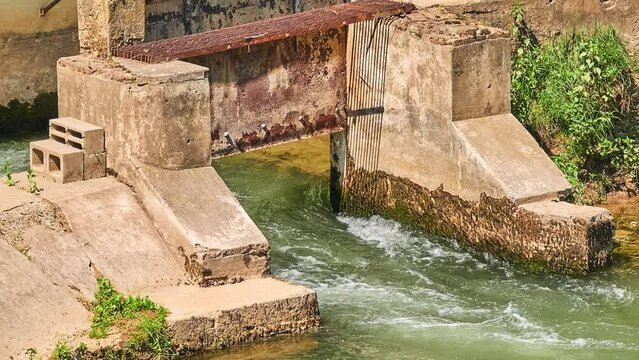 Small dam on Bacchiglione River in historic center of Vicenza, Italy. View from the bridge to Contra Pusterla Street.