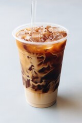 a cup of iced coffee with a straw
