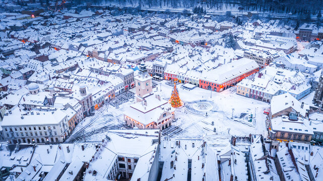 Brasov, Romania, Transylvania - Council Square and Christmas Tree, aerial winter view.