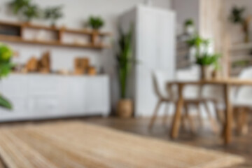 Blurred view of modern living room with sofa and soft bench. room interior with  couch, armchair and coffee table or shelving units. stylish living room. comfortable workplace near big window.