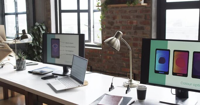 Modern business workspace is equipped with a laptop, two monitors, and various office supplies