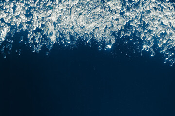 underwater splash bubbles in water environment, blue background with copy-space