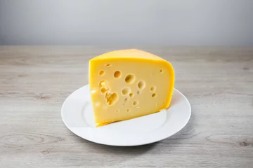Foto op Plexiglas maasdam cheese on a plate, grey background © nikkytok