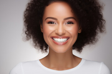 A photo portrait of a beautiful black woman over 30 years old, smiling with clean teeth, perfect teeth. To advertise dentistry. Highlighted on a white background - obrazy, fototapety, plakaty