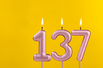 Candle 137 with flame - Birthday card on yellow luxury background