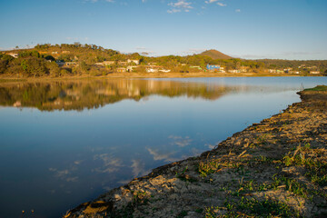 Beautiful morning by the lake, with blue sky and reflections in the water, located in Esmeraldas, Minas Gerais.