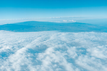 Aerial photography of Honolulu to Hilo from the plane.  From left to right: Mauna Kea, Mauna Loa, and Hualalai. Hawaii island
