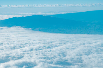 Aerial photography of Honolulu to Hilo from the plane.  From left to right: Mauna Kea, Mauna Loa, and Hualalai. Hawaii island
