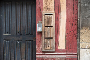 Old wooden letterboxes on the wall of an old house