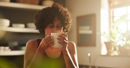 Woman, smelling coffee and scent on morning, calm and relaxing with hot beverage at home. Female person, thoughtful and peaceful drink or contemplation on weekend, daydreaming and aroma in kitchen