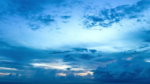 Aerial hyper lapse view amazing cloud moving in blue sky at blue sunrise above the ocean..scenery stunning sky colorful cloud over the islands in Rawai sea Phuket Thailand..Sky texture.