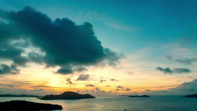 aerial hyper lapse view yellow light in blue sky at blue sunrise above the blue sea..Scene of yellow light through the clouds above islands..Gradient color. Sky texture, abstract nature background.