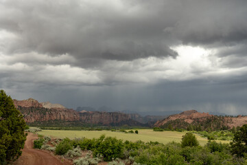 Fototapeta na wymiar Summer Rain Drops over Field and Mountains of Zion