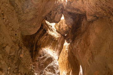 Obraz premium Karadakh gorge. Sunlight in a mountain Canyon. Beautiful curved crevice in sunny weather. Creation erosion of yellow sandstone by water acquired twisted shape natural Origin. Dagestan, Russia, Europe