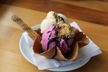 scoops of ice cream in an ice cream cone.