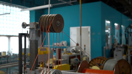 Steel wire coils at a tire factory. Creative. Rotating and reeling metal threads bobbins at modern...