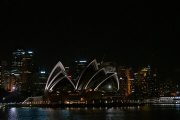 Fototapeta na wymiar Glowing Sydney opera house at night.