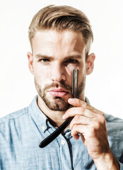 Barbershop. Closeup portrait of stylish bearded man with straight razor. Vintage barber shop....