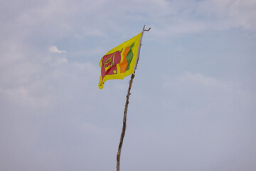 Sri Lankan flag flying in wind on Bentota Beach, southern Sri Lanka
