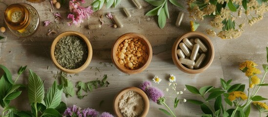 Various types of herbs are neatly arranged in wooden bowls on top of a table. The assortment of herbs showcases different colors, textures, and aromas, creating a visually appealing display.