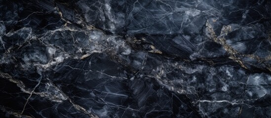Dark black and white marble texture closeup, showcasing intricate veins and patterns, suitable for use as a background or backdrop in design projects.