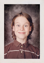 Bad school portrait of an awkward grinning boy