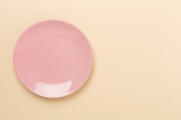 Empty plate on color background, top view