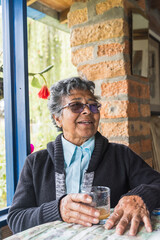 Mother's day. Happy mother smiling enjoying her day at the farm. Older brunette woman with glasses very happy.