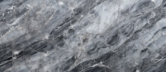A black and white marble texture background is displayed on a table, showcasing intricate veins and patterns characteristic of marble.