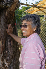 Mother's day. Happy mother smiling enjoying her day at the farm. Older brunette woman with glasses very happy.