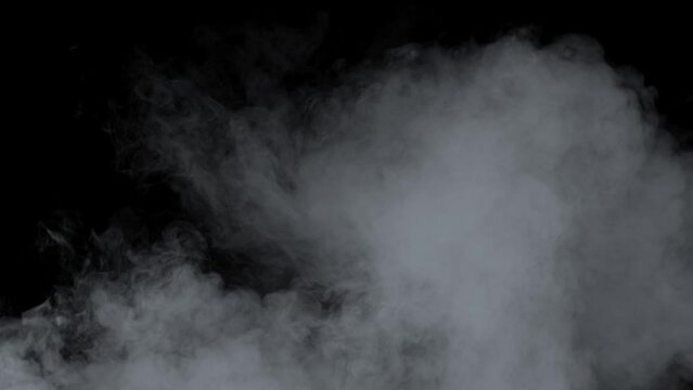 Smoke. Cloud of cold fog in blue light spot on black background. Abstract white smoke in slow motion. Light, white, fog, cloud, abstract, smoke, black, background, 4k, ice smoke cloud. Floating fog.	