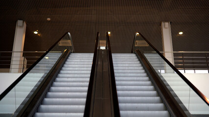 Empty moving staircase running up and down. Media. Modern indoor escalator stairs.