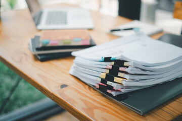 Stack overload document report paper with colorful paperclip place on office desk, paperless...