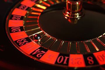Closeup view of roulette wheel with ball. Casino game