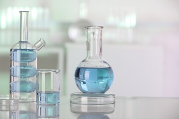 Laboratory analysis. Different glassware with liquid on white table indoors. Space for text