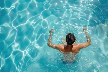 Deurstickers Young man relaxing in resort swimming pool.  © 2D_Jungle