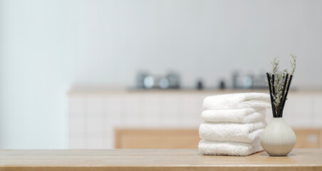 Stack of white clean towels on wooden table