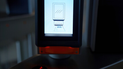Close up of electronic turnstile with plastic card entering system. Media. Using smartphone with...