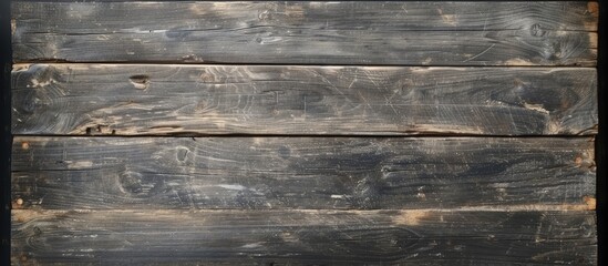 The top-down view captures an aged wooden wall with a dark gray texture. The intricate patterns and details of the wood are highlighted in this black and white photograph.