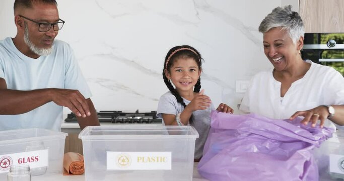 Biracial family sorts recycling in a bright kitchen; the child is excited
