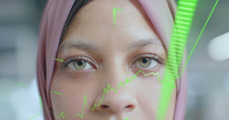 Image of financial data processing over biracial businesswoman in hijab in office