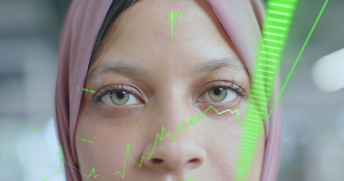 Image of financial data processing over biracial businesswoman in hijab in office