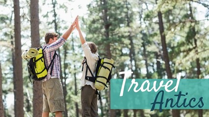 Travel antics text on blue band over caucasian couple wearing backpacks high fiving in forest